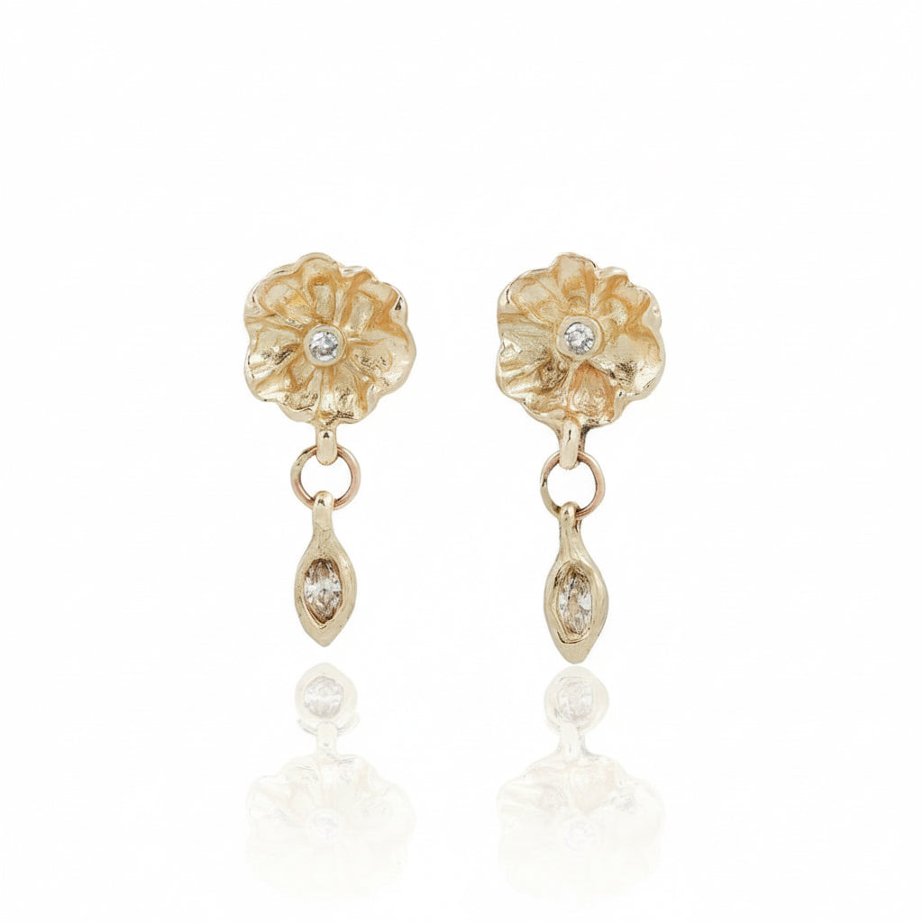 Front view of handcrafted 14k yellow gold flower earrings featuring 2mm round diamond centers and suspended marquise-cut diamond drops.