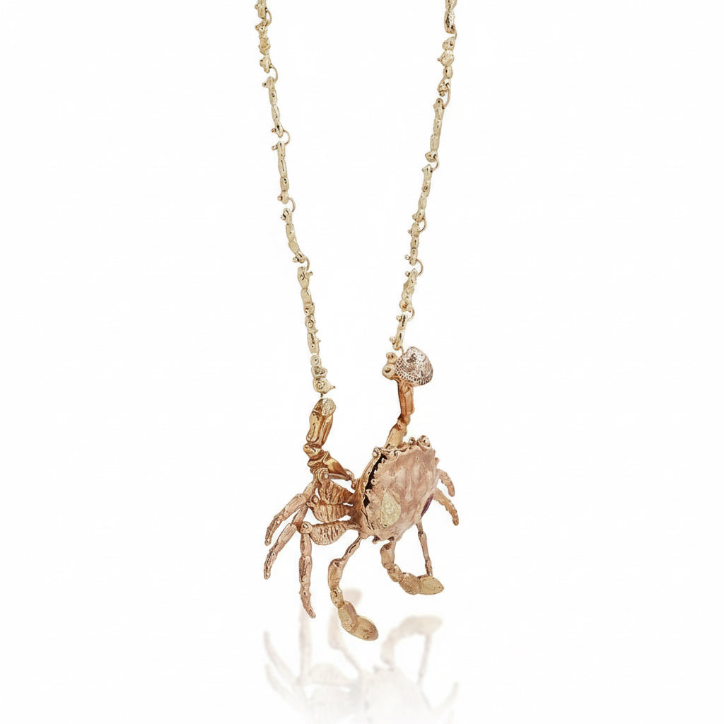 Full view of the 17-inch Gold Kinetic Crab Locket necklace, featuring a sculptural 14k rose gold crab pendant with movable legs, ruby detail, and an articulated yellow gold coral chain.