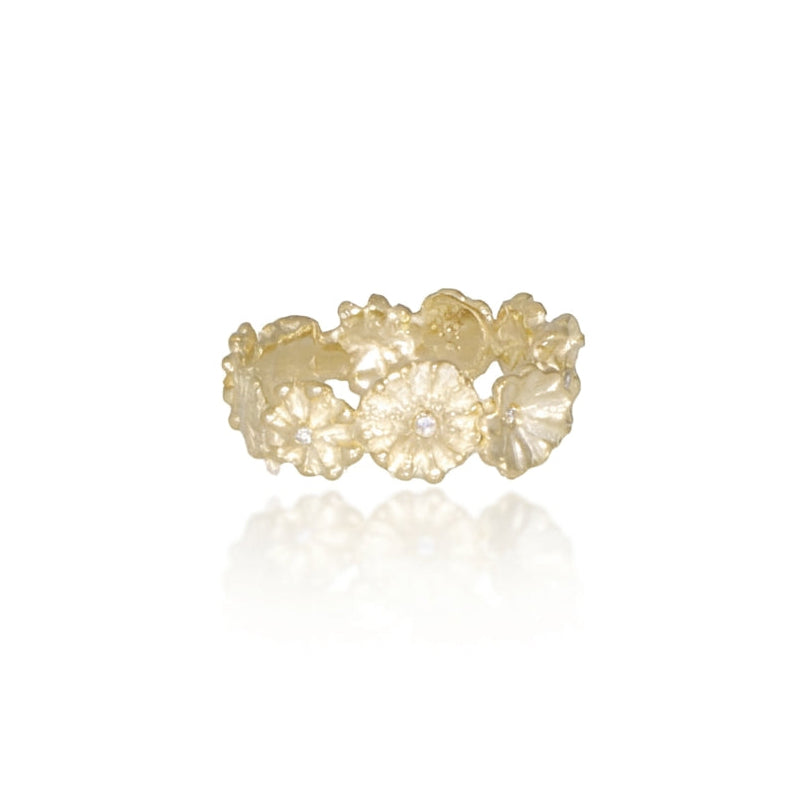 Front view of the Efflorescent Sparkle Ring featuring a repeating hand-carved flower pattern in solid 14k yellow gold accented with five natural diamonds.