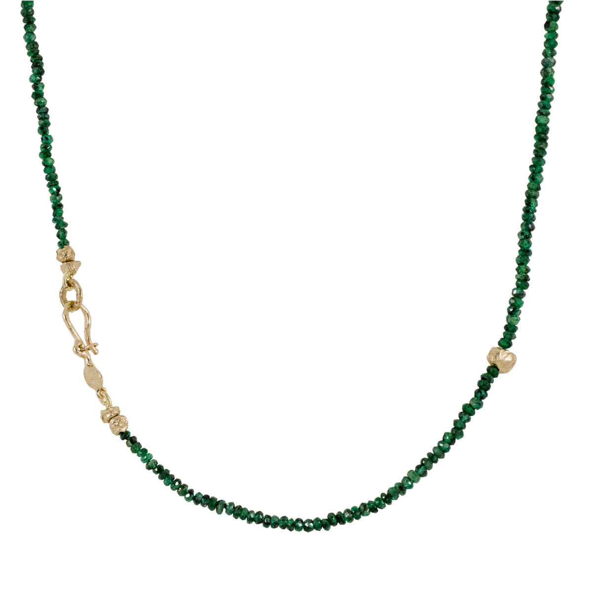 Full view of an 18-inch natural emerald beaded necklace with scattered 14k yellow gold accents, a hand-carved gold rock bead, and a sculptural gold clasp.