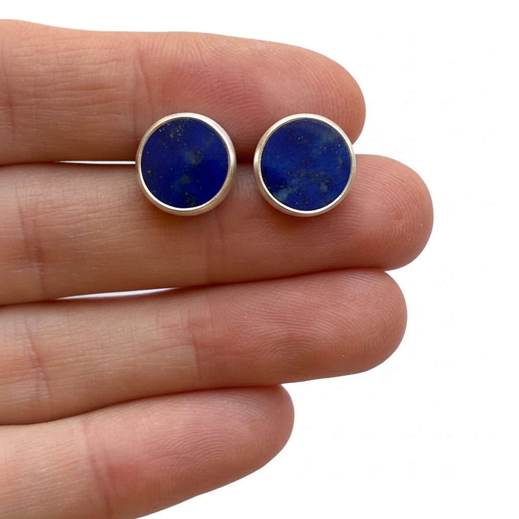 Lapis lazuli round earrings held between fingers