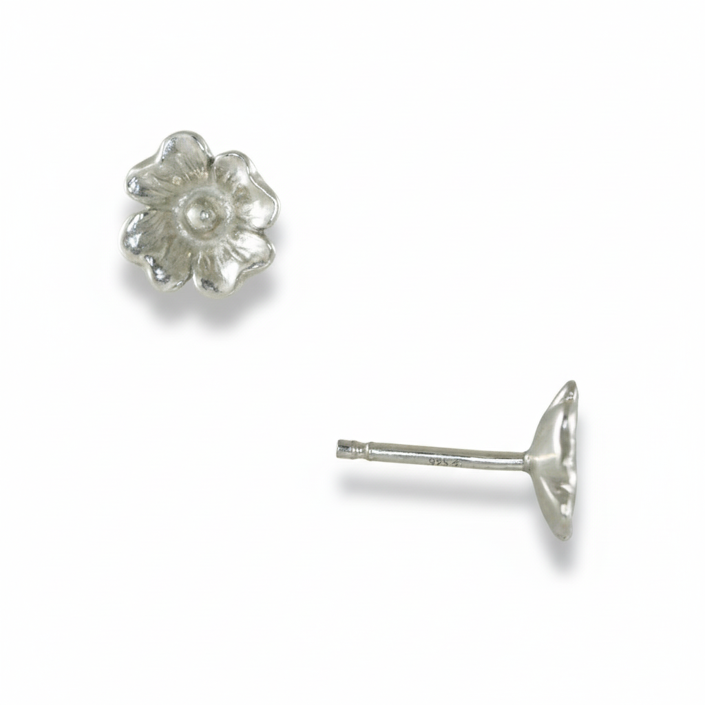 Silver dogwood flower stud earring shown from front and side on a white background.