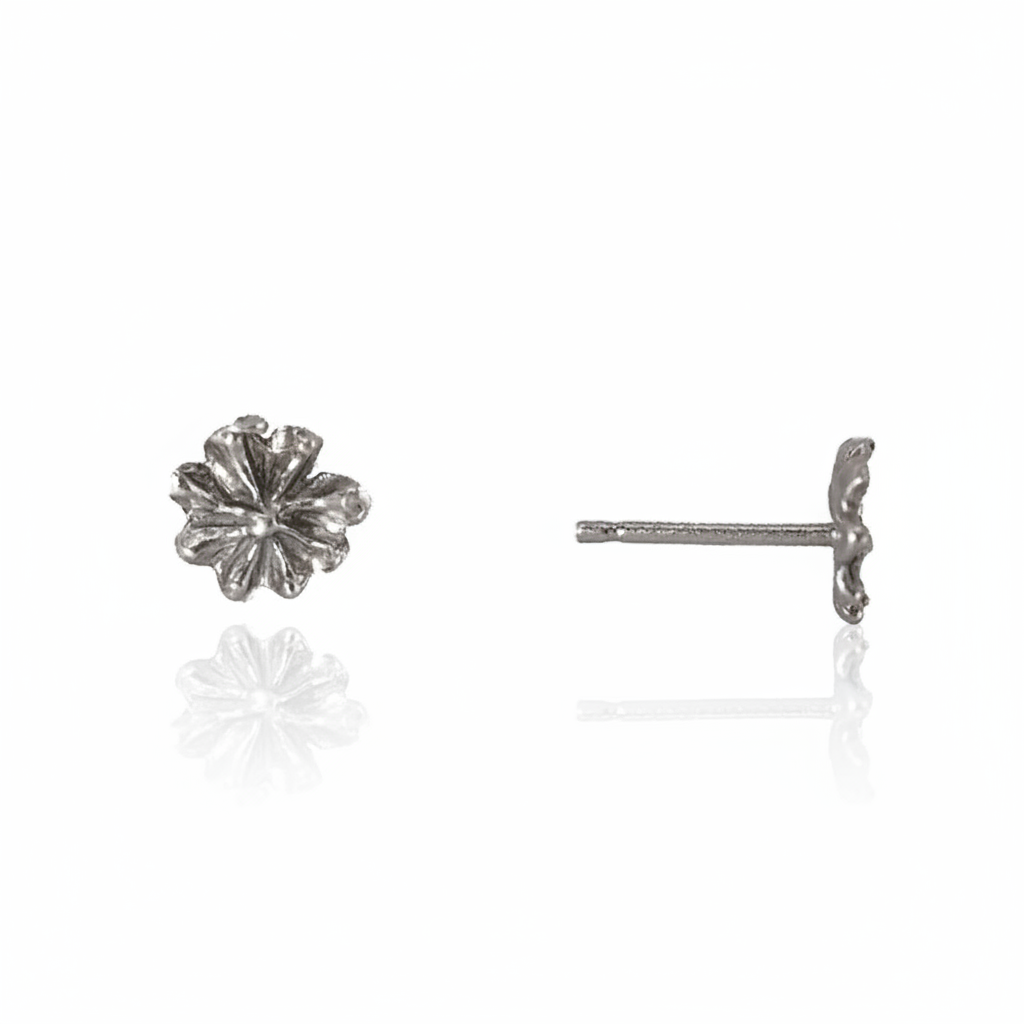 Front and side views of Efflorescent Small Stud Earrings in sterling silver by Alexis Pavlantos, featuring hand-carved floral petals, a 5mm diameter, and delicate post closures.