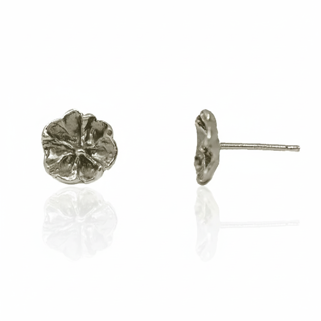 Front and side views of Efflorescent Stud Earrings in sterling silver by Alexis Pavlantos, featuring a 9mm hand-carved floral design with textured petals and post closures.
