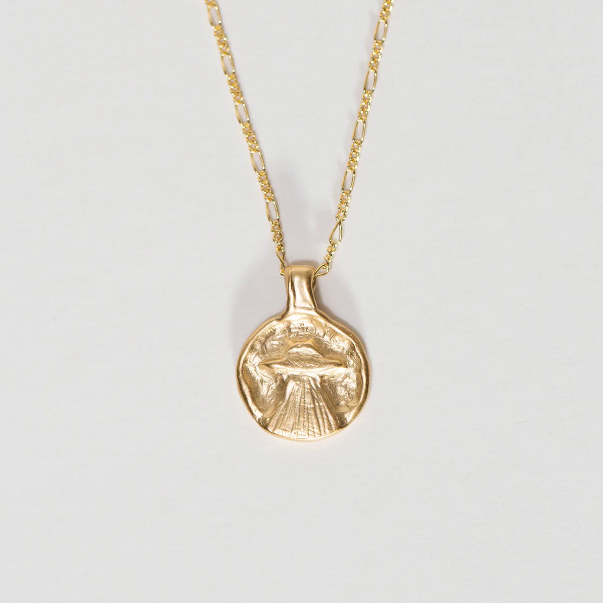 Gold vermeil UFO pendant necklace on a Figaro chain shown against a light background.