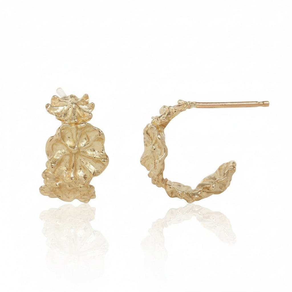 Side view of 14k yellow gold Efflorescent floral hoop earrings showing their dimensional hand-carved flower design and post closures.