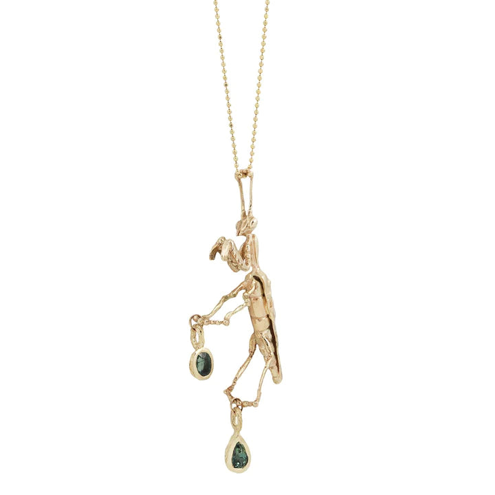 Full view of the handcrafted 14k yellow gold Praying Mantis Necklace, highlighting the detailed mantis sculpture, dangling sapphire accents, and fine gold chain.