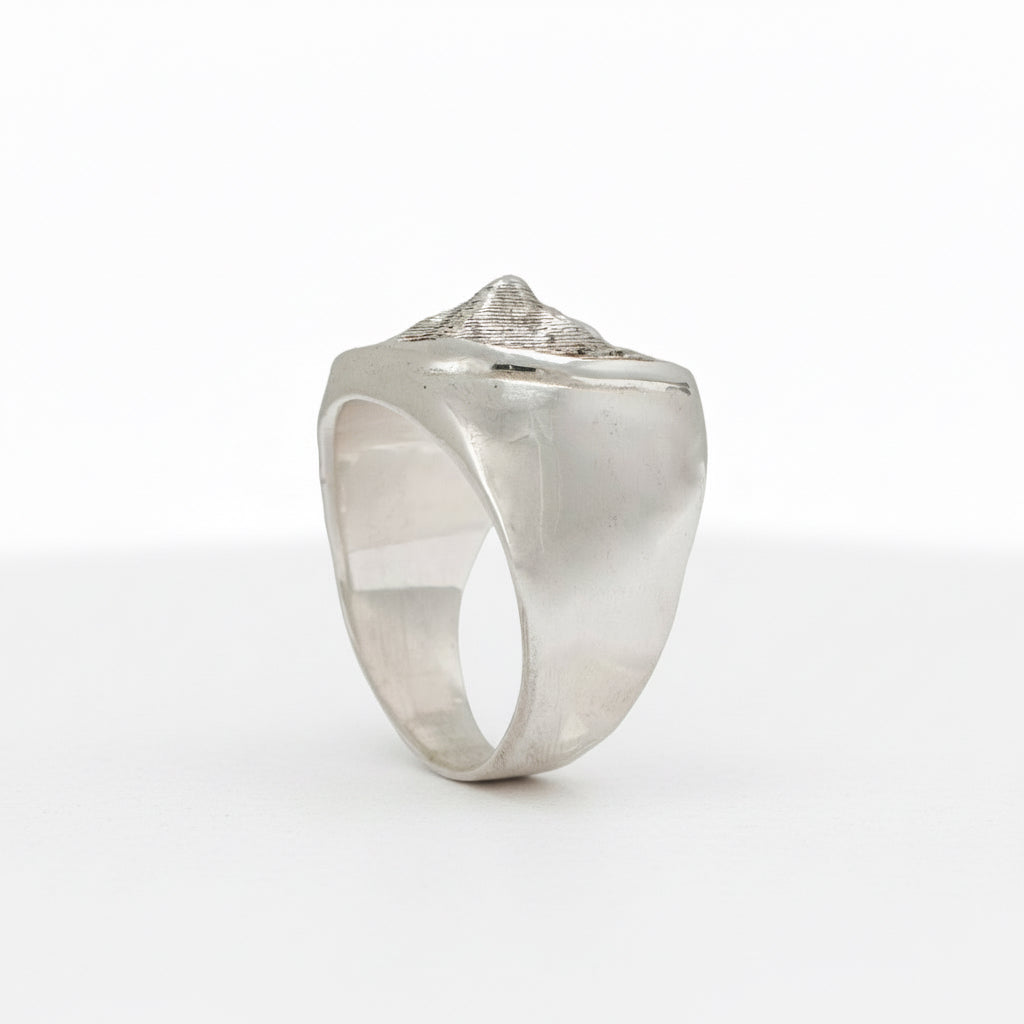 Side view of the handcrafted Sandia Crest sterling silver signet ring with sculpted design.