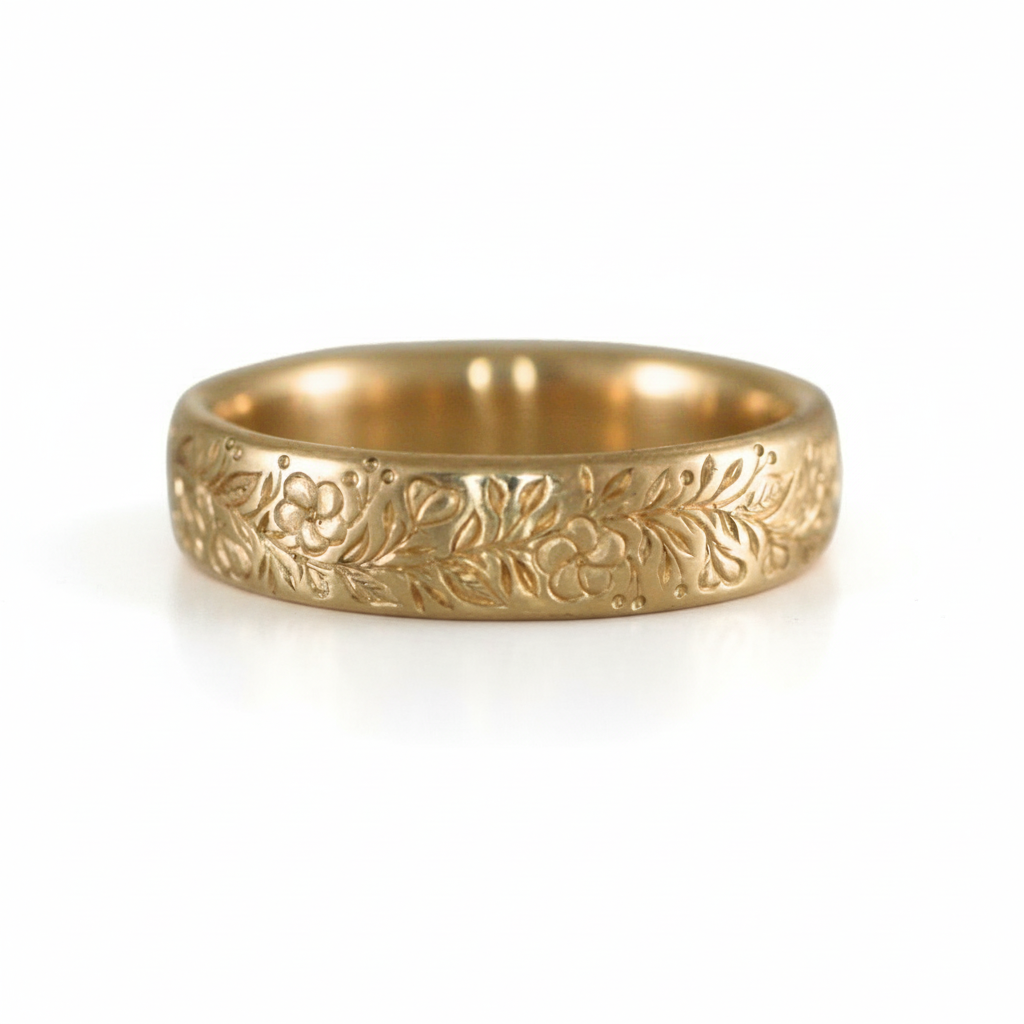 14k gold hand-engraved floral band ring displayed on a white background.