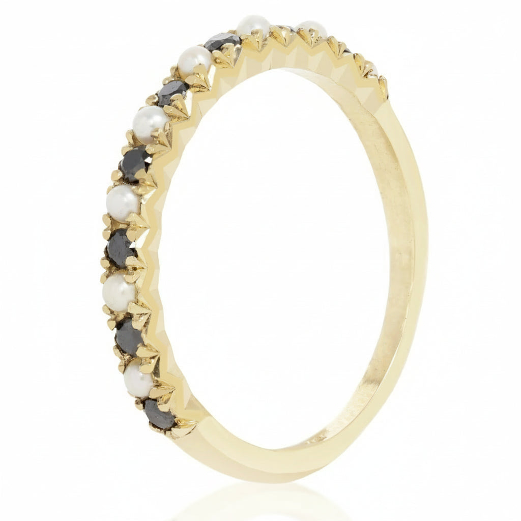 Side view of 14k gold band set with seed pearls and black diamonds