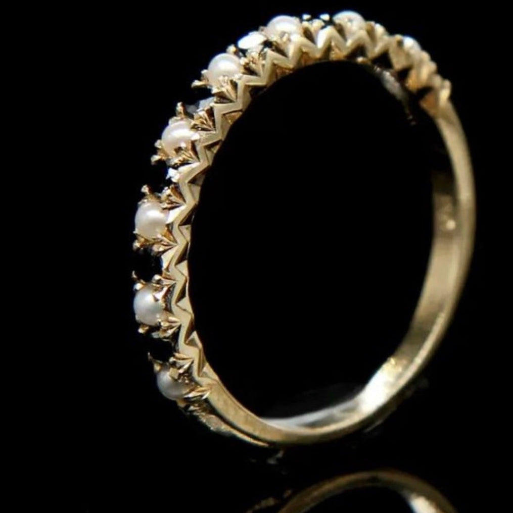 Luxury photo of 14k gold ring featuring pearls and black diamonds