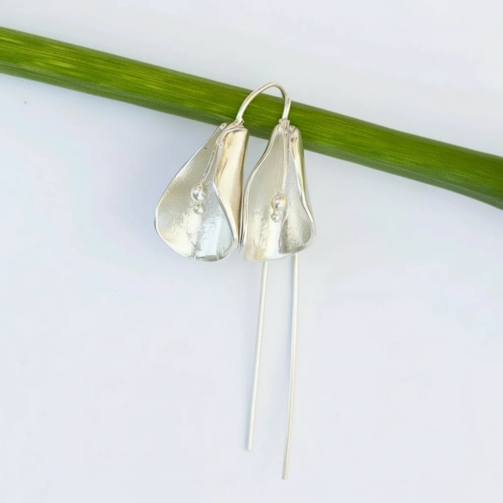 Silver Calla Flower earrings on a white background with a green stem