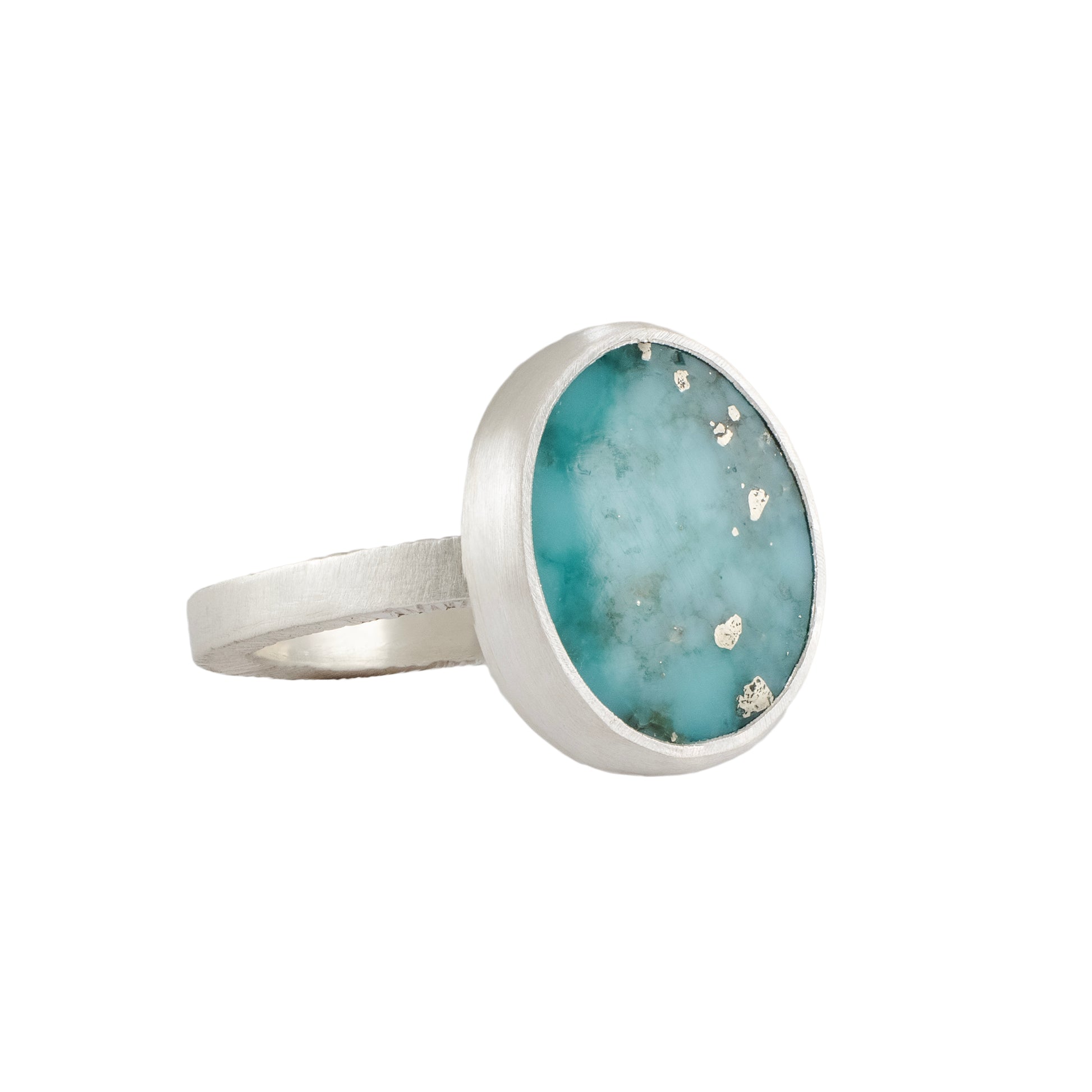 Silver ring with a turquoise stone on a white background