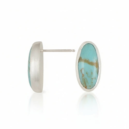 Turquoise stone stud earrings with silver rims on a white background