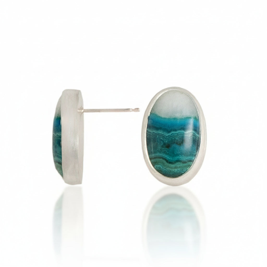 Oval-shaped earrings with blue and green stone on a white background