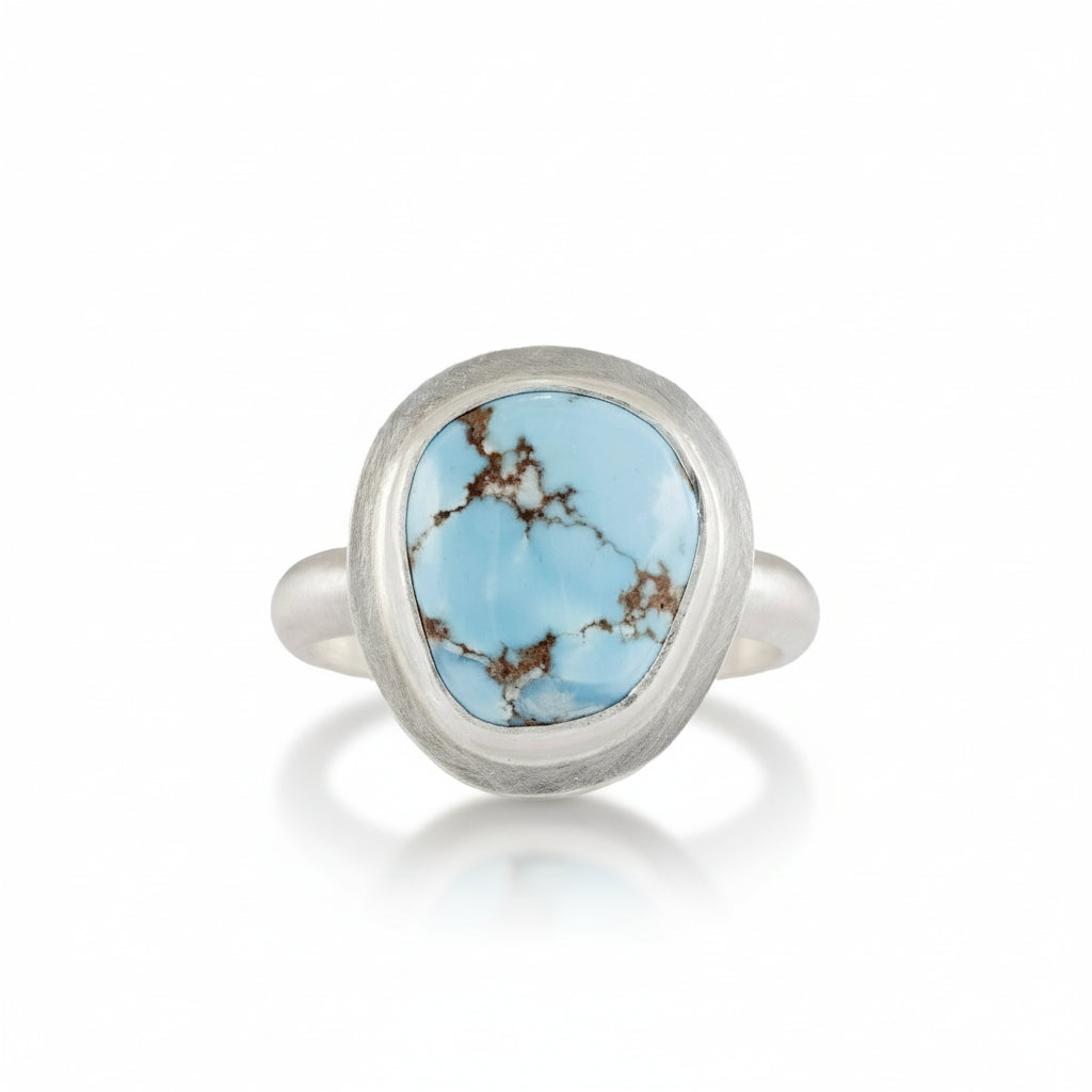 Silver ring with a turquoise stone on a white background