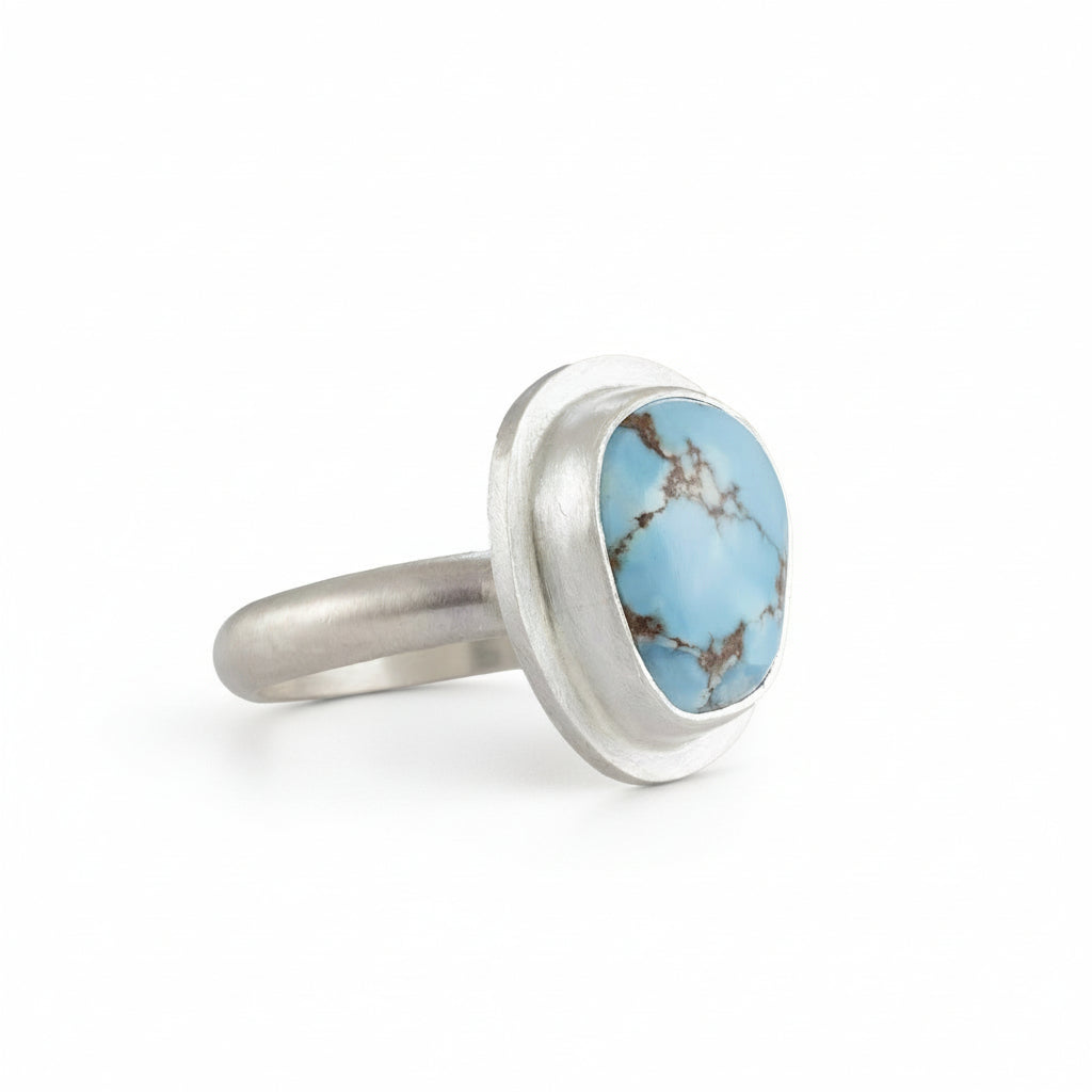 Silver ring with a Turquoise stone on a white background