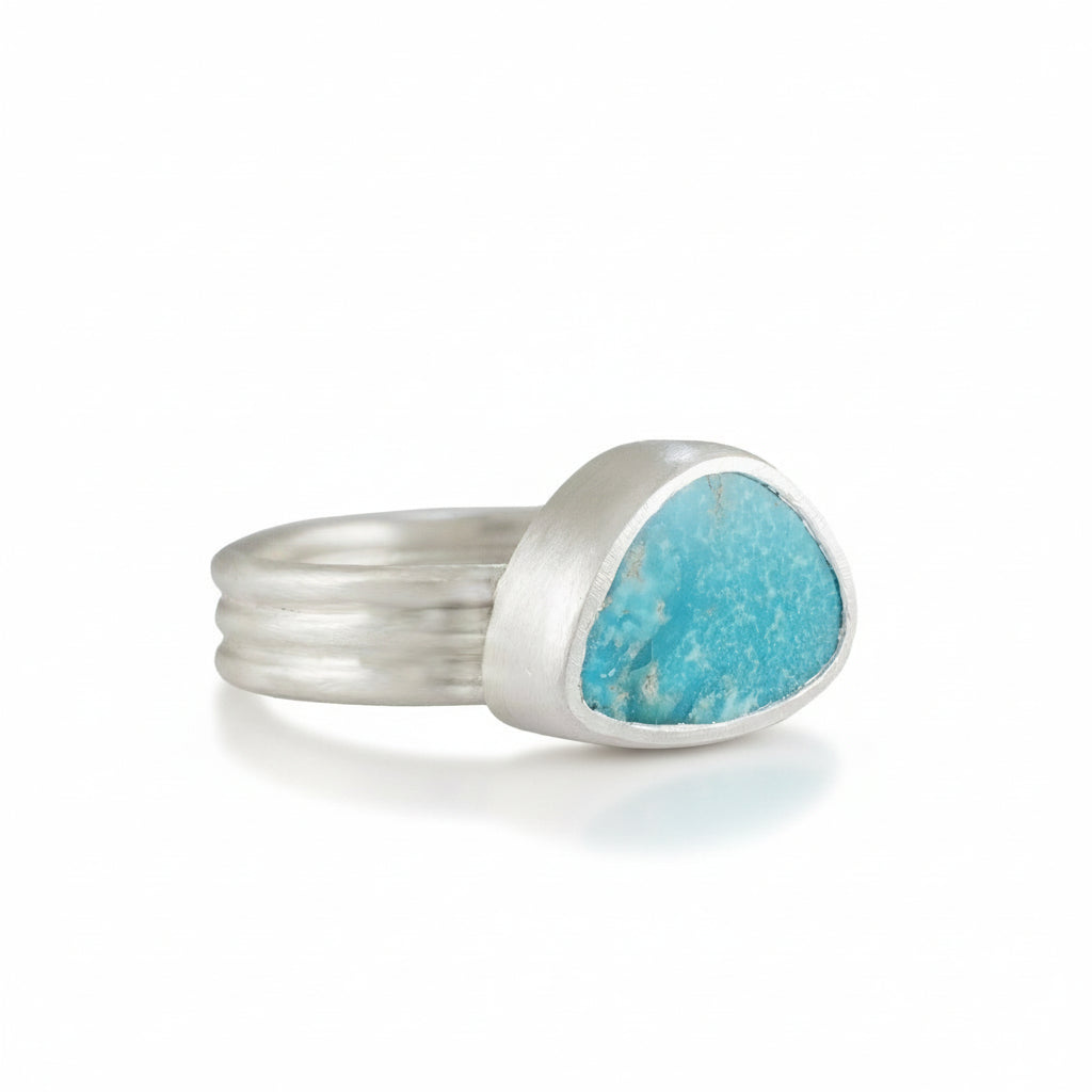sterling Silver ring with a Turquoise stone on a white background
