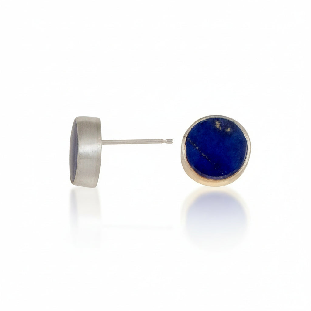 Pair of round stud earrings with blue lapis lazuli stone on a white background