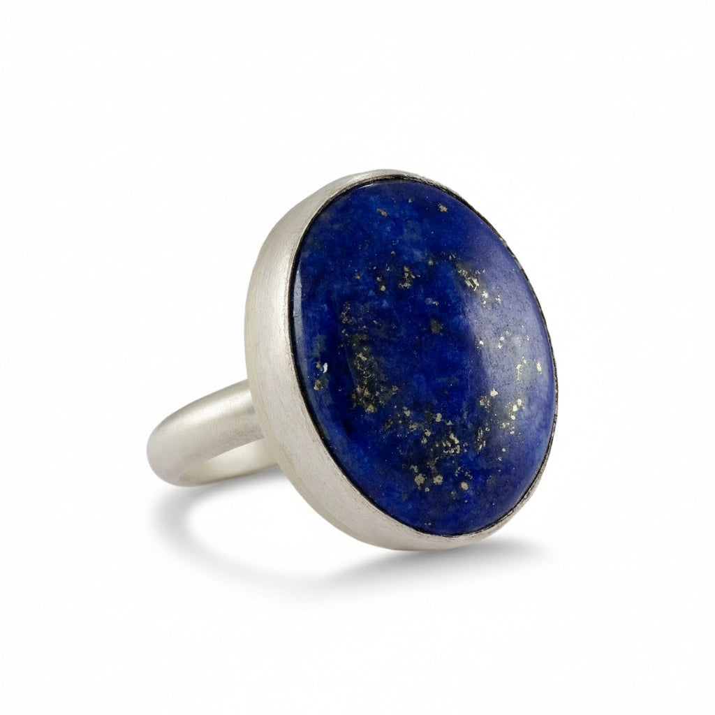 Silver ring with a lapis lazuli stone on a white background