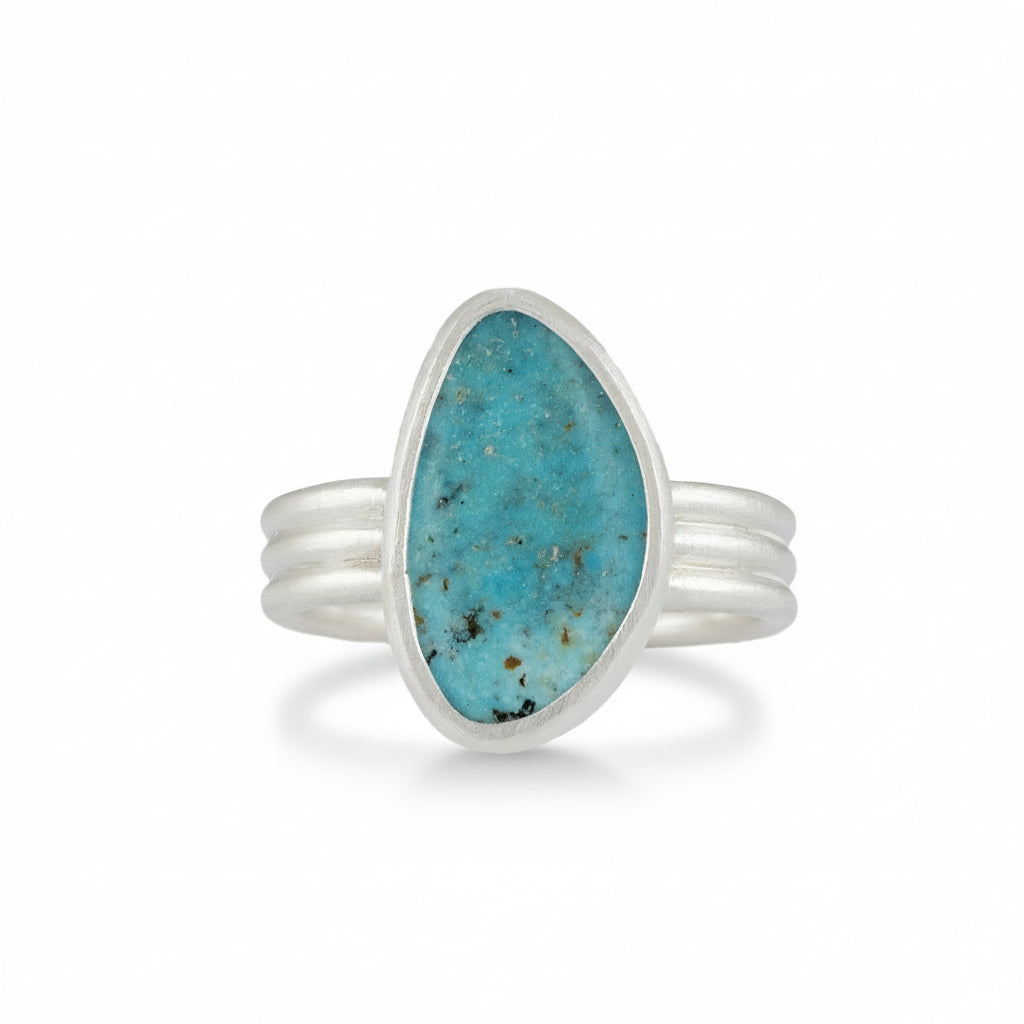 Silver ring with a turquoise stone on a white background