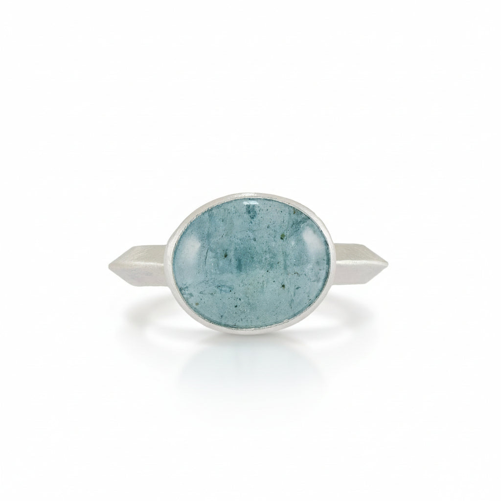Silver ring with a tourmaline stone on a white background