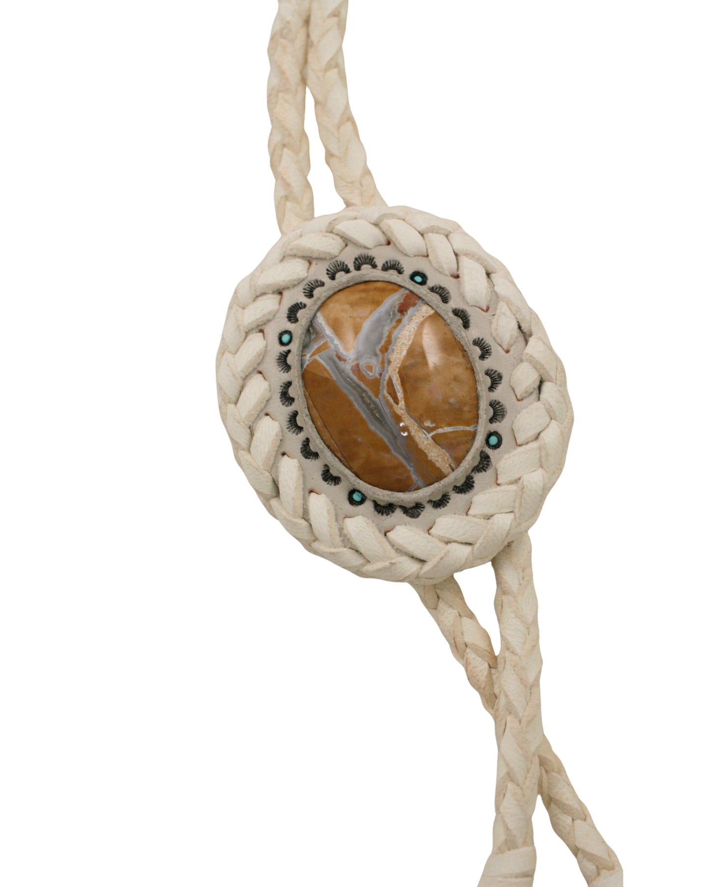 Close-up of hand-tooled white leather bolo tie featuring a Willow Creek jasper stone centerpiece by Kelly Horrigan Handmade, shown on white background.