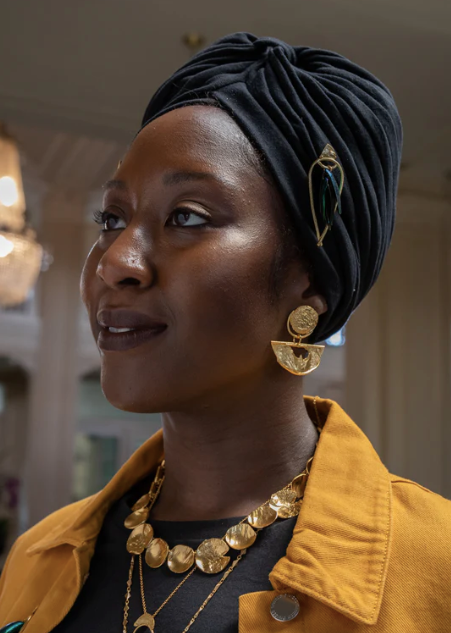 Hits the Horizon Earrings by Alicia Goodwin in 22k gold plated brass shown on model wearing a black headscarf and gold necklace