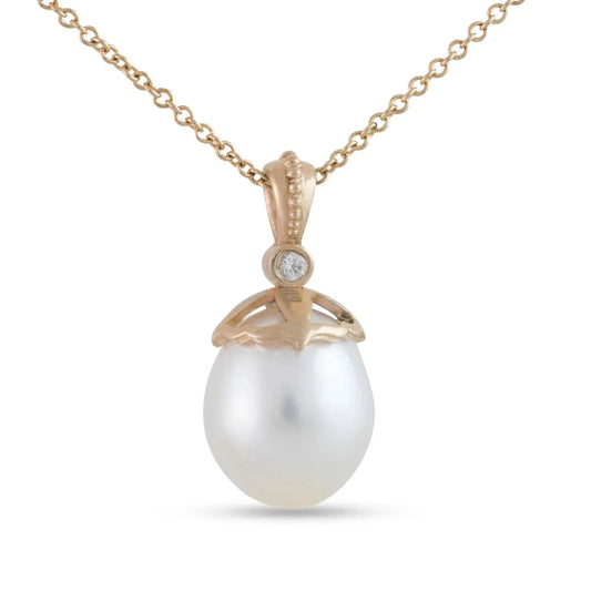 White South Sea pearl necklace by Michaela Farkasovska with two white diamonds and a sculptural 14k yellow gold pendant.