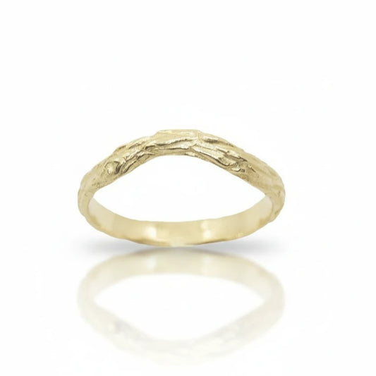 Aura Sprig Ring by Alexis Pavlantos in 14k yellow gold, featuring an organic hand-carved texture inspired by wood and a gently arched band, photographed on white.