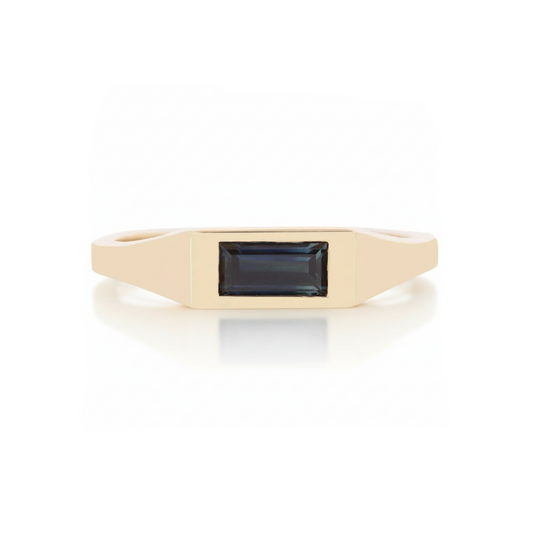 14k yellow gold signet ring by Adeline Jewelry featuring a horizontal deep blue sapphire baguette set in a sleek, polished tapered band.