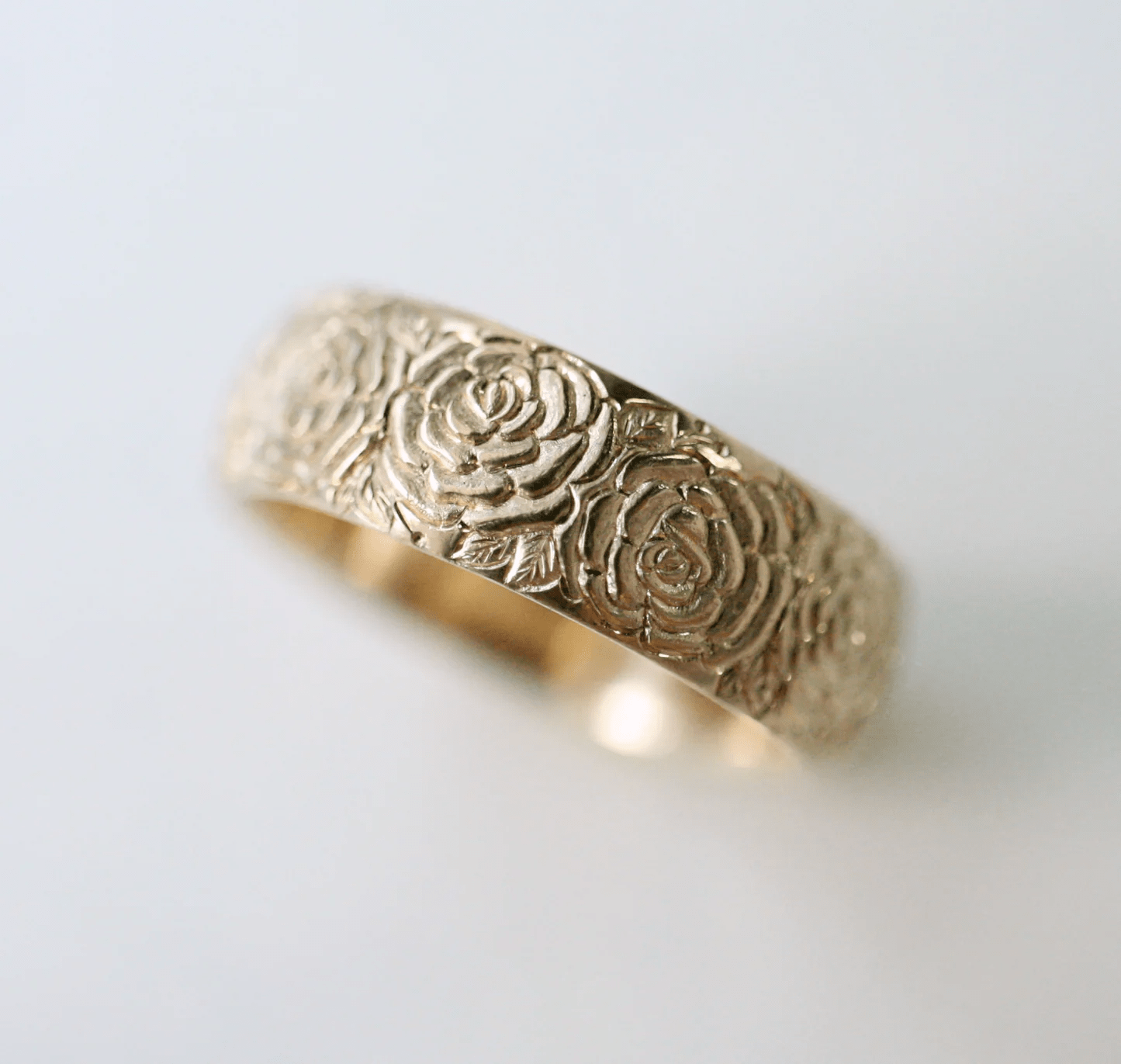 Hand-engraved 14k gold band ring by Blue Blue Driver shown in a front view on a white background.