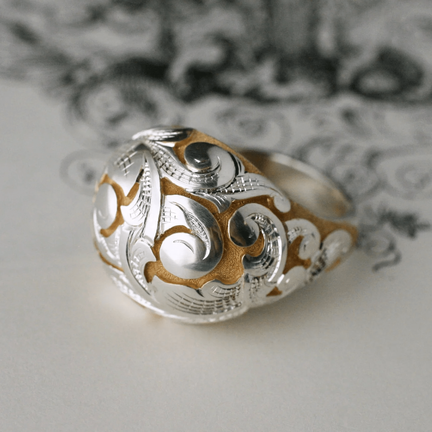 Side angle of the sterling silver and gold Acanthus Bombe Ring by Blue Blue Driver.