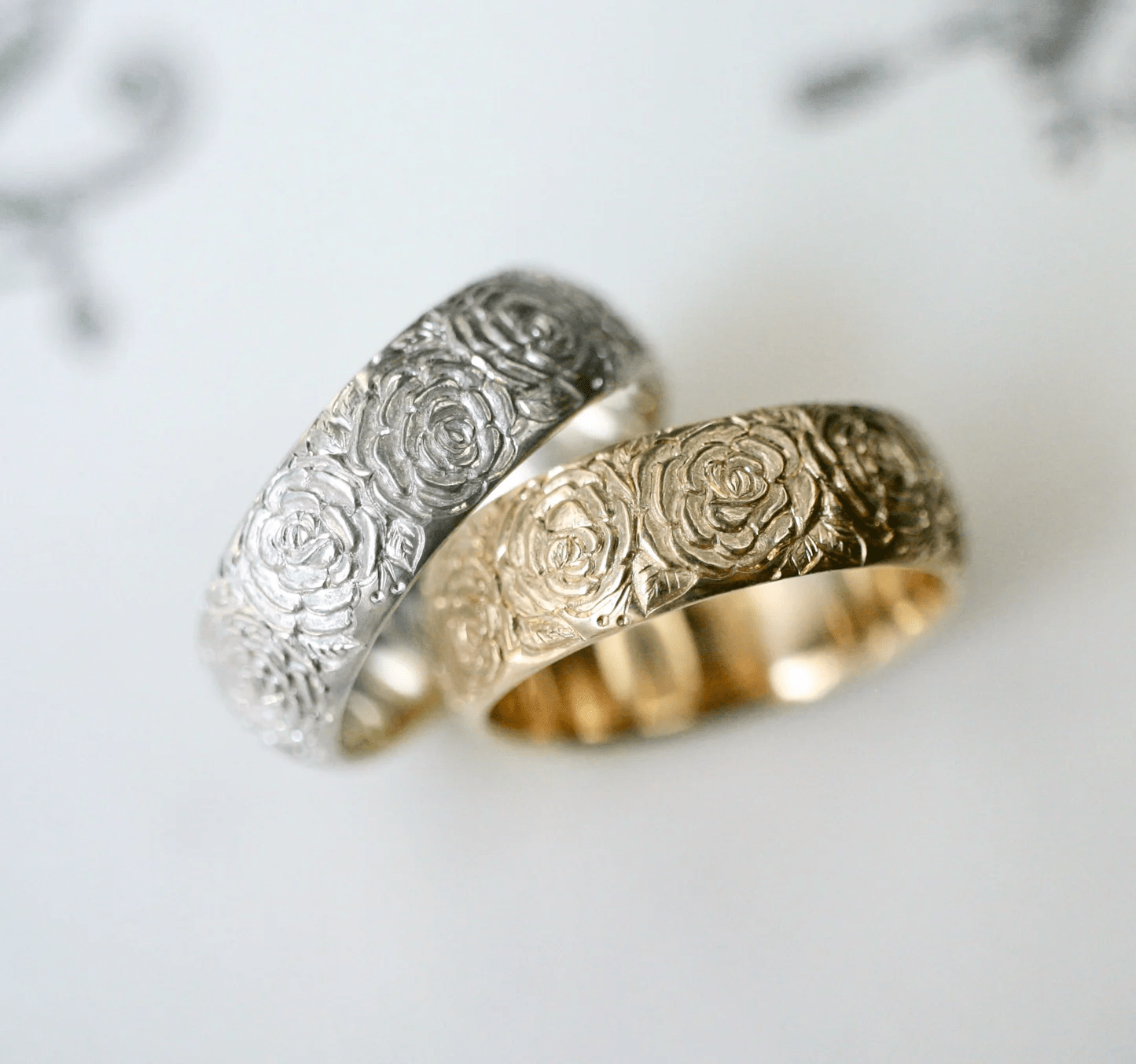 Sterling silver and 14k gold Beloved Rose band rings by Blue Blue Driver shown side by side for comparison.