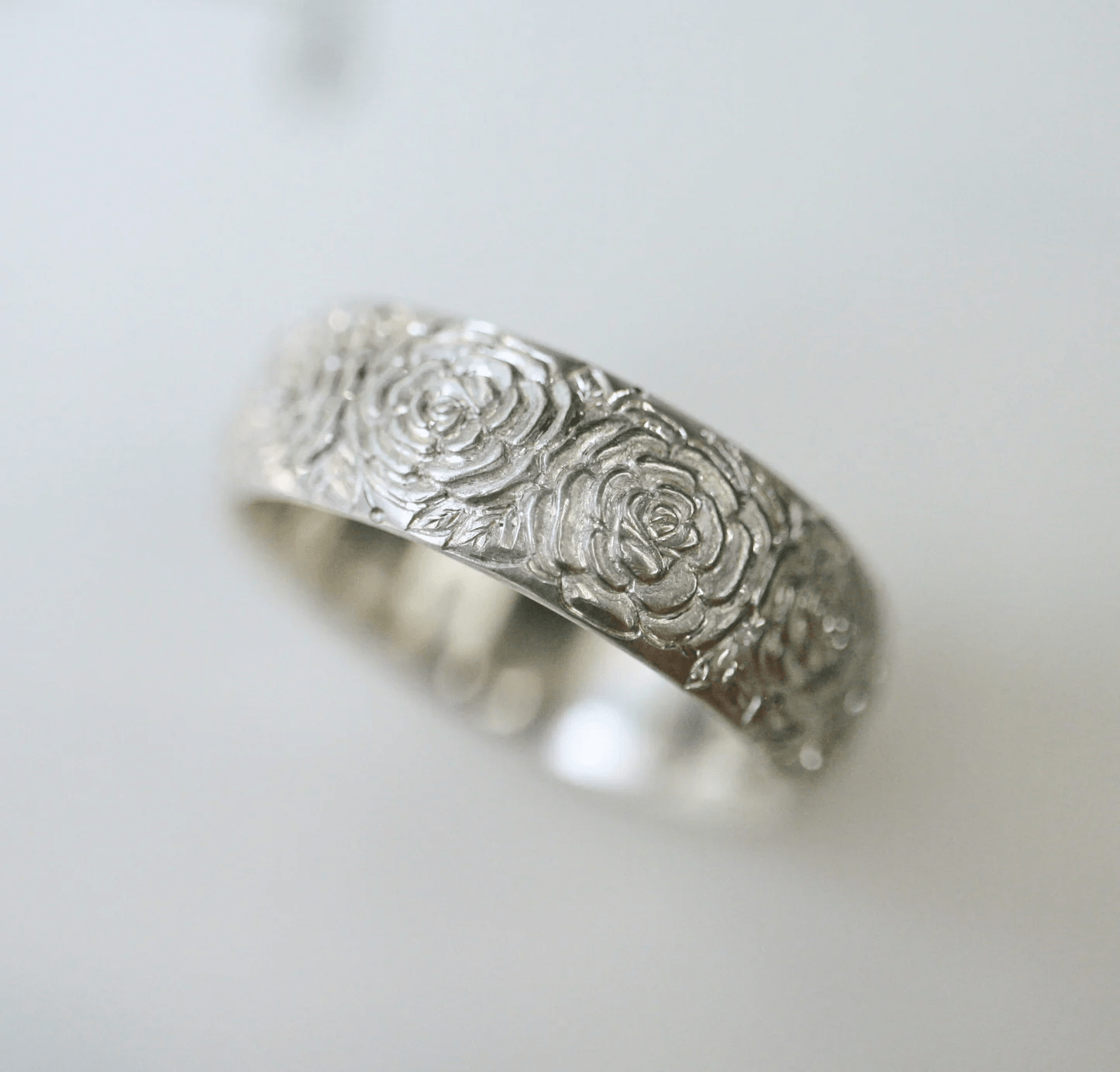 Front view of the hand-engraved sterling silver beloved band ring by Blue Blue Driver on a white background.
