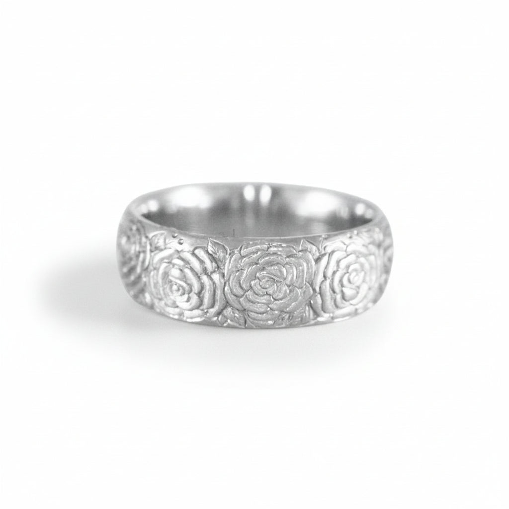 Front view of the hand-engraved sterling silver Beloved Rose band ring by Blue Blue Driver on a white background.