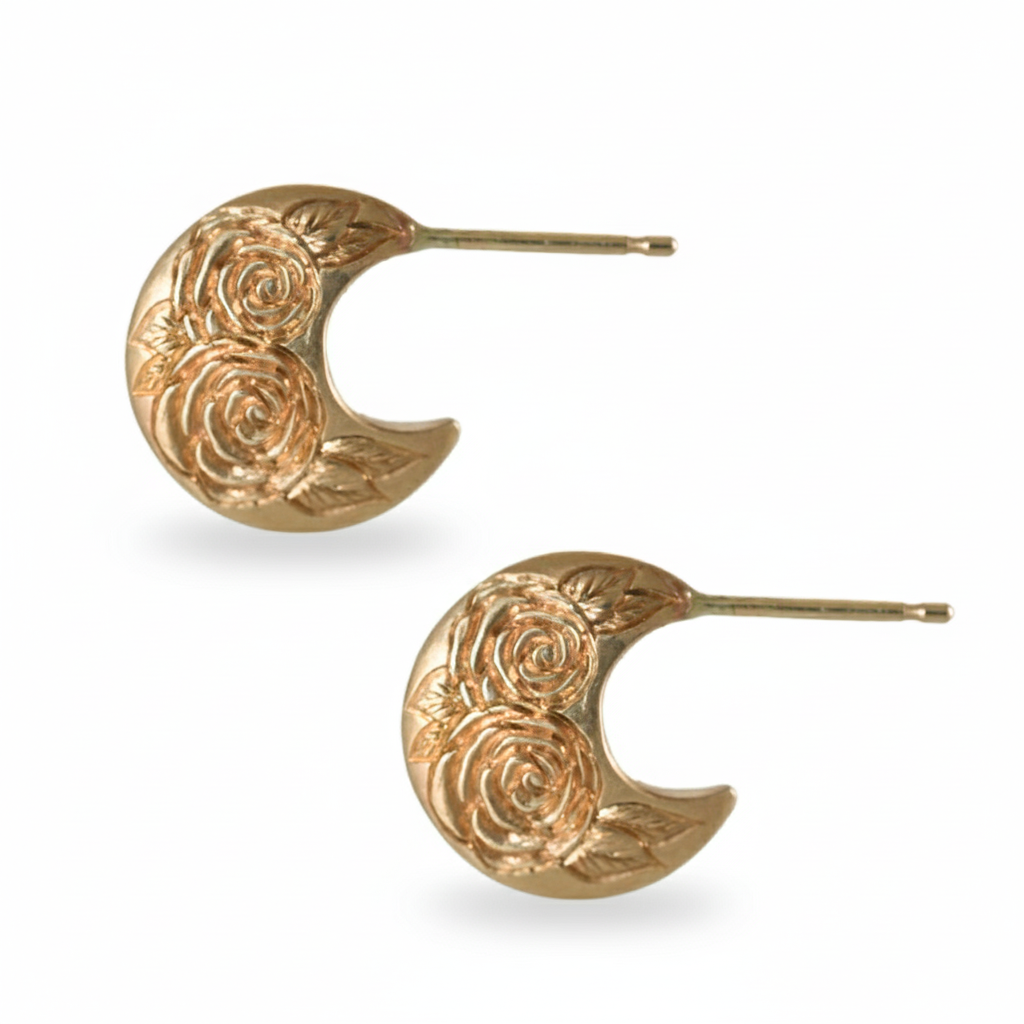Pair of gold crescent rose-engraved earrings on a white background
