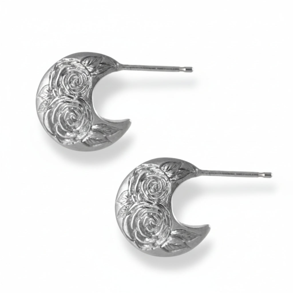 Sterling silver Beloved Rose disc hoop earrings with hand-engraved rose patterns on a white background.