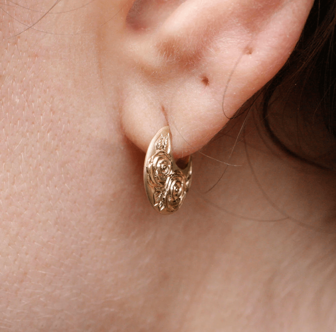 Angled view of the 14k gold Beloved Rose earrings by Blue Blue Driver worn on the ear.