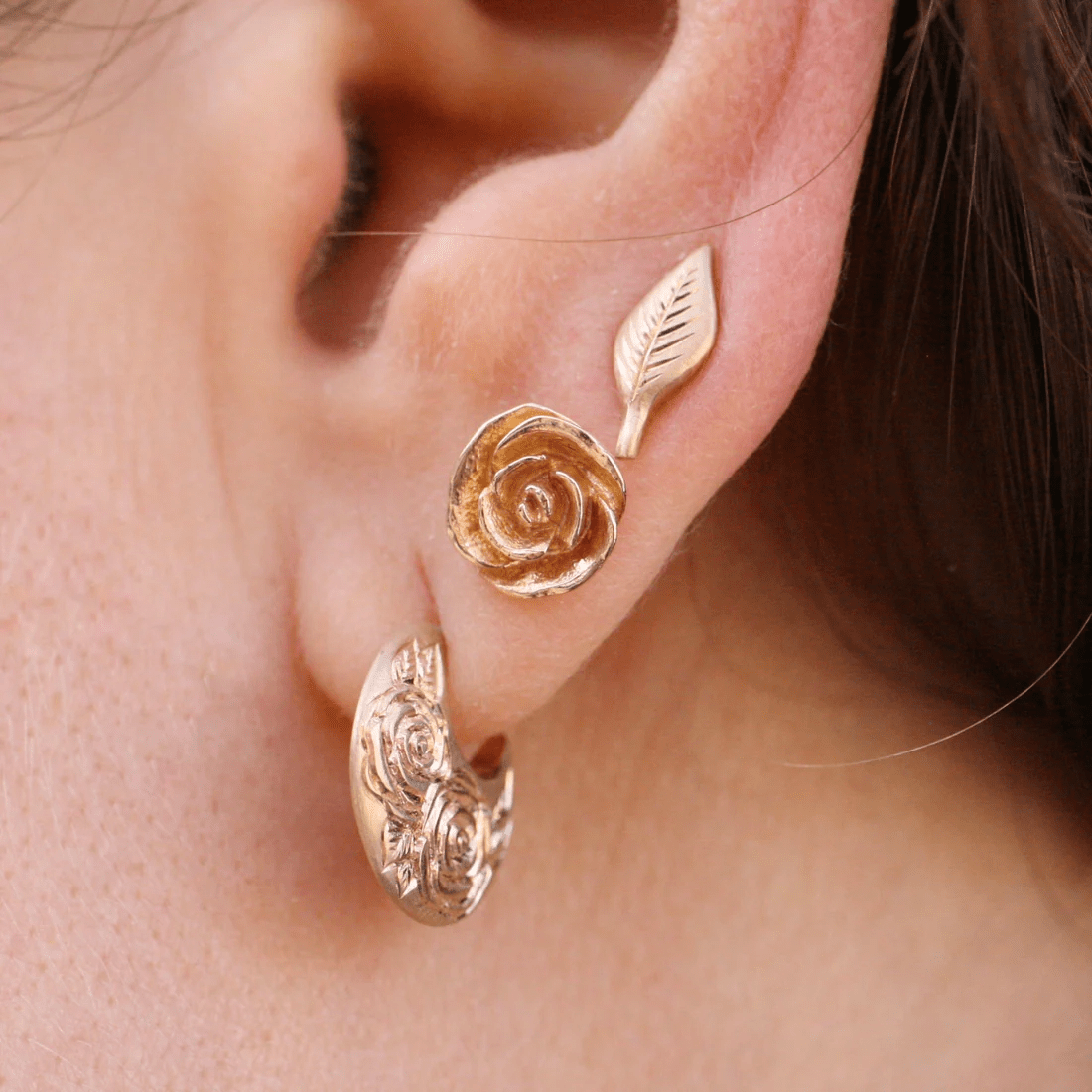 Front ear view of the 14k gold Beloved Rose earrings by Blue Blue Driver, showing detailed rose engraving.