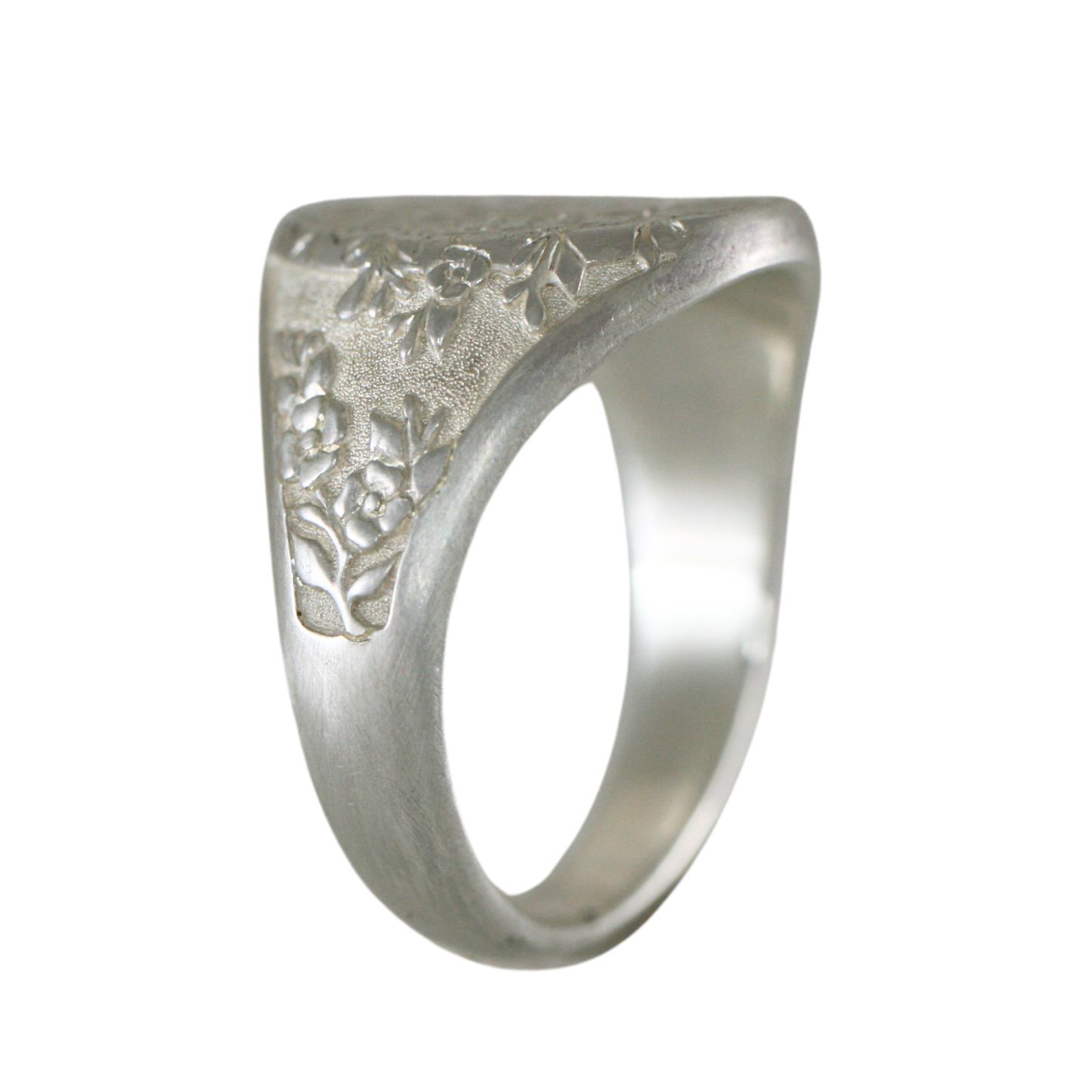Sterling silver Dogwood signet ring shown from the side, featuring detailed floral engraving.