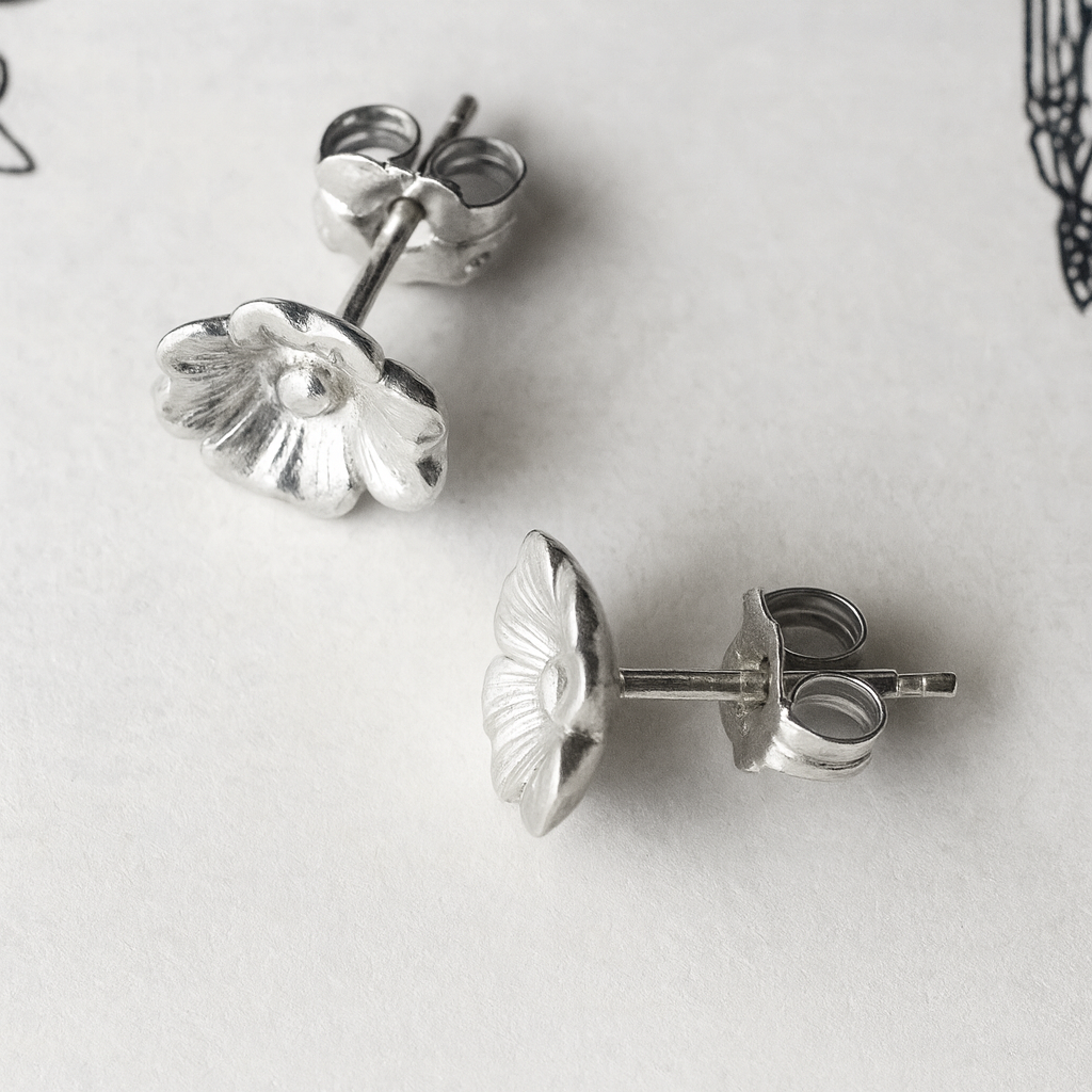Front view of silver dogwood flower stud earrings.