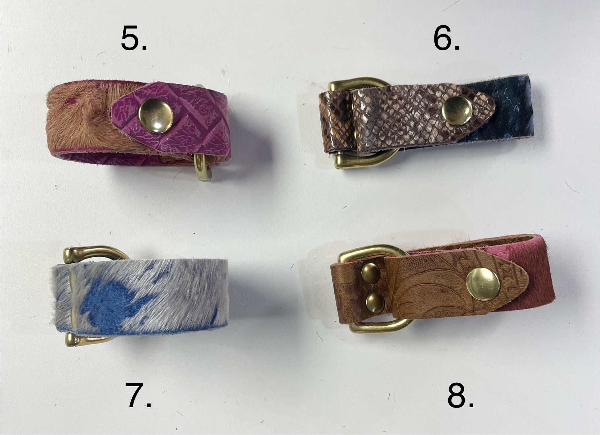 Close-up of Badass Leather Cuff Bracelet with bold cowhide pattern and brass snaps.