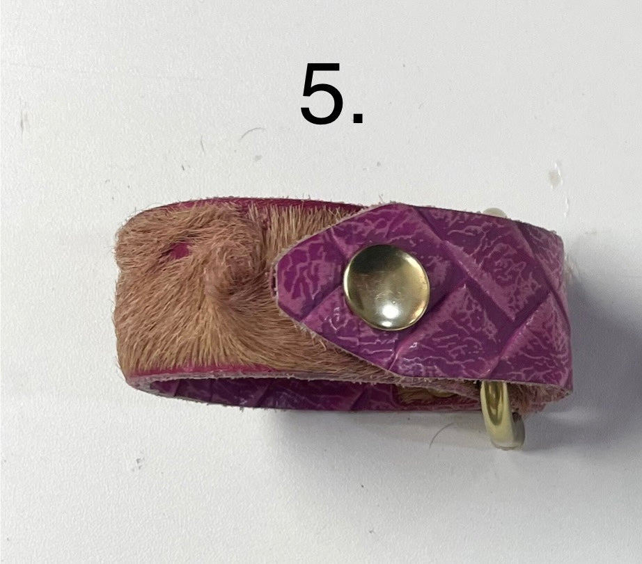 Purple cowhide leather cuff bracelet with brass hardware and hand-cut edges.