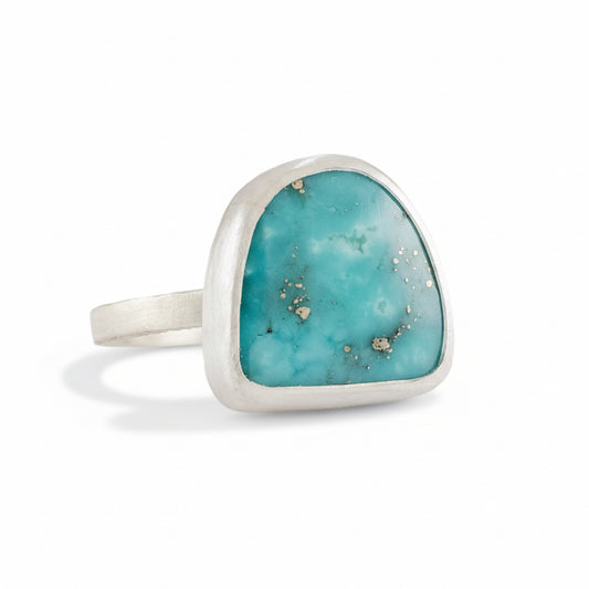 Campitos Turquoise Ring by Ana Eugenia, featuring a bright blue freeform turquoise cabochon with natural matrix in a brushed sterling silver bezel setting.