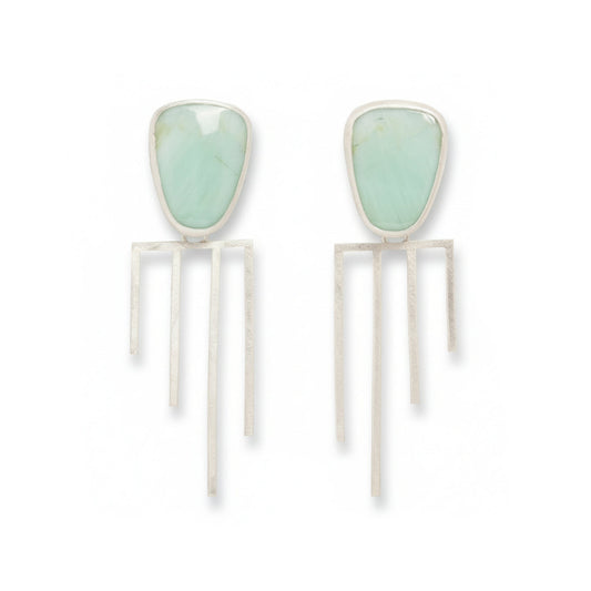 Carmen Earrings by Ana Eugenia, featuring pale green petrified wood opal cabochons set in sterling silver with long, geometric dangling silver accents.
