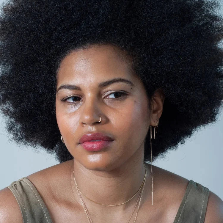Model wearing the 14k gold chain threader earring in a close-up portrait.