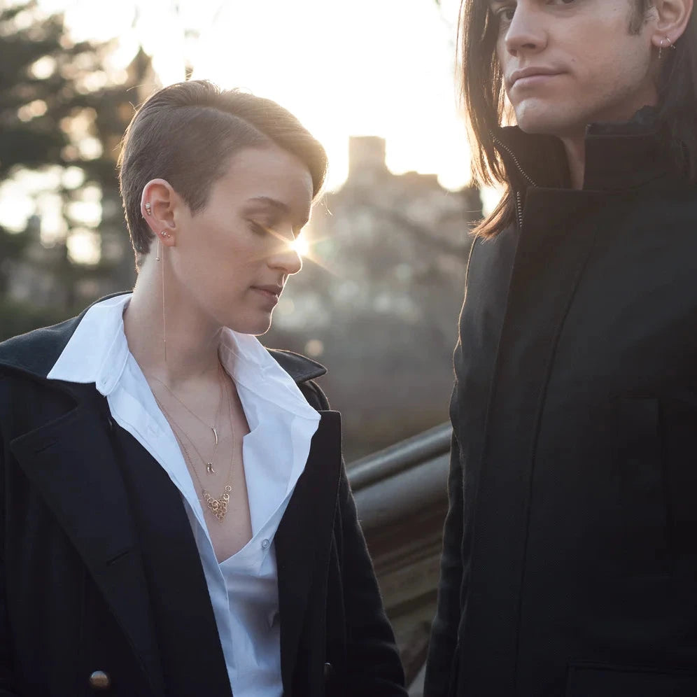 Lifestyle photo showing the 14k gold chain threader earring worn outdoors.