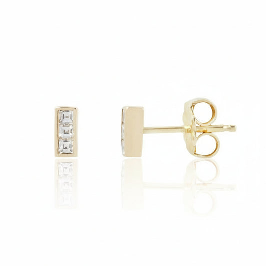 KIMA Channel Set Stud Earrings in solid 14k yellow gold, featuring three carré-cut white diamonds per earring in a minimalist rectangular design.