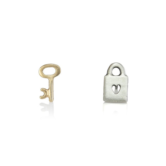 Charmed Love Stud Earrings by Luana Coonen, featuring a tiny 14k yellow gold key and a sterling silver padlock with a heart-shaped keyhole.